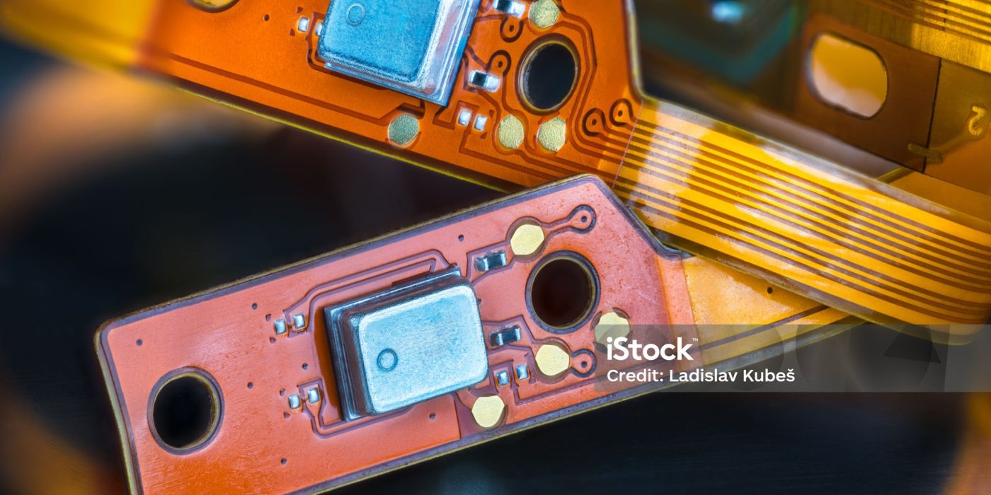 istockphoto-1464585805-2048x2048 (1) Closeup of bendy PCB or small components on flexible ribbon cables from inside of headphones